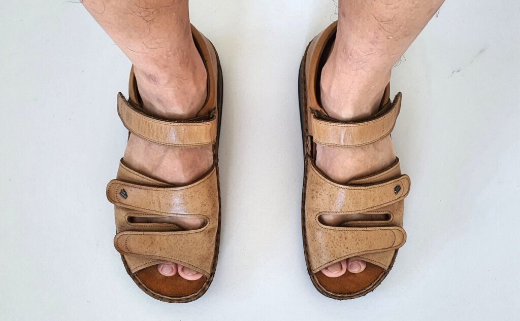 A pair of tan-colored Finn Comfort Baltrum sandals.